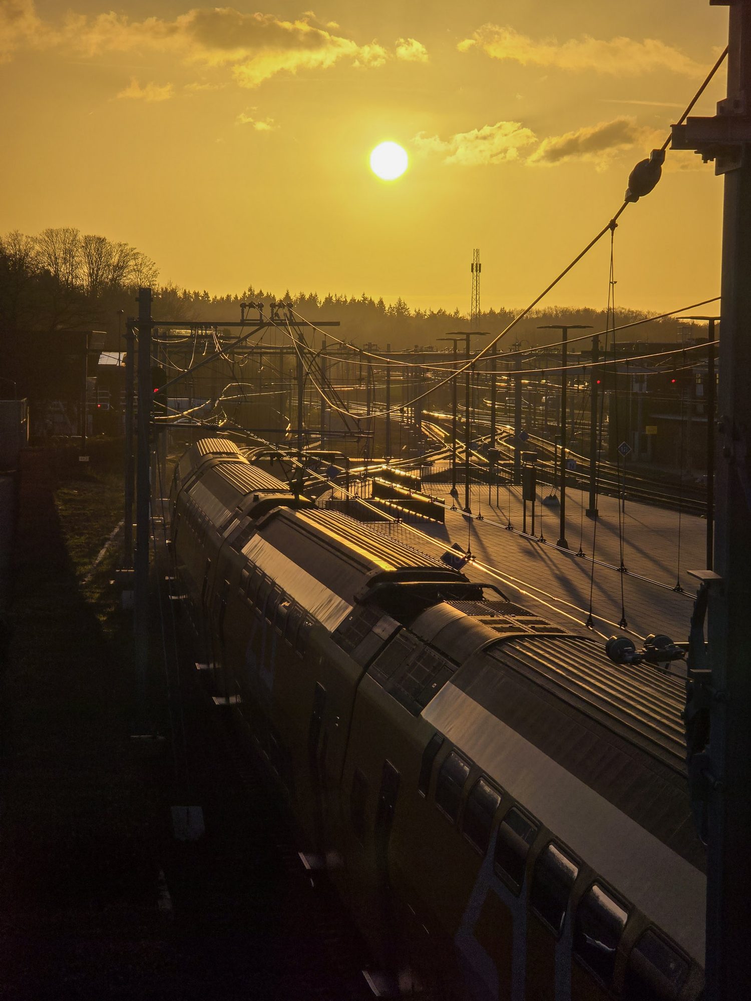 Trein op een station bij ondergaande zon